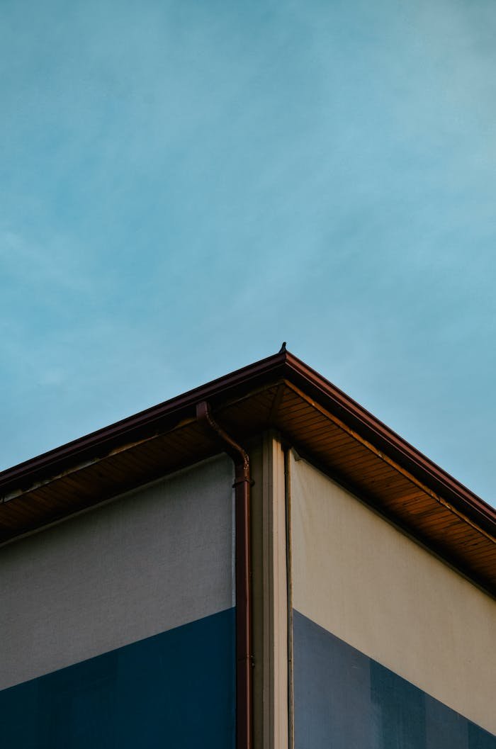 A corner view of a modern building against a clear blue sky.